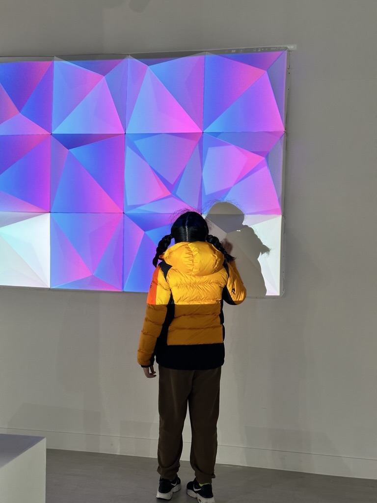 A visitor engaging with the interactive projection