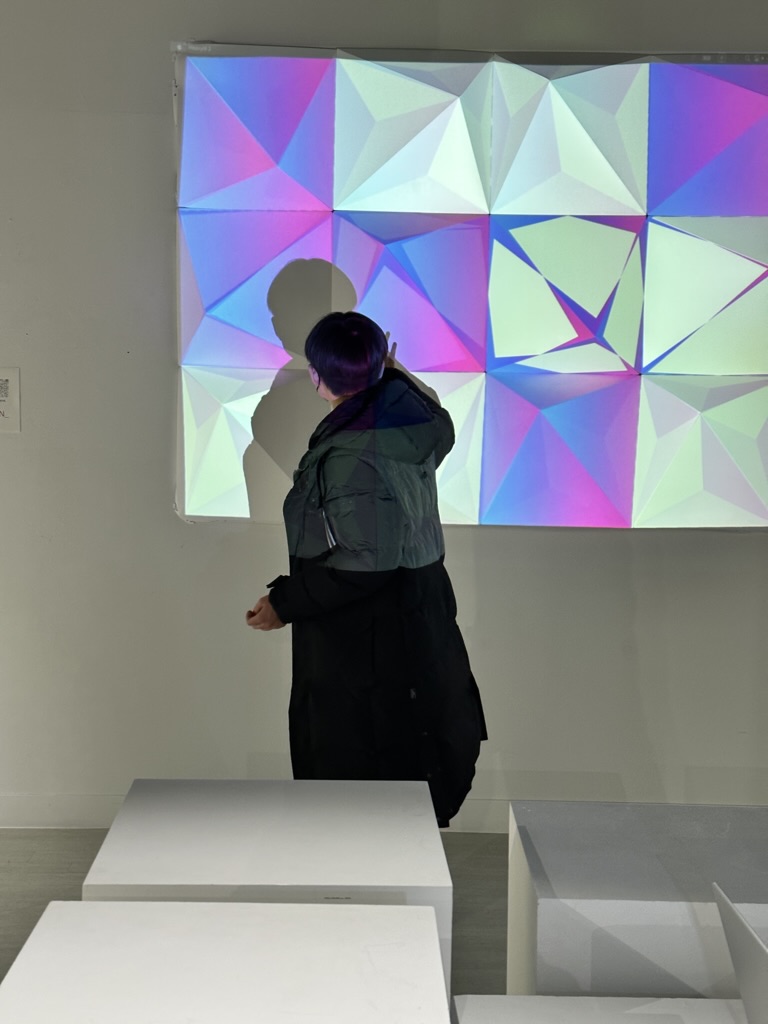 A visitor engaging with the interactive projection